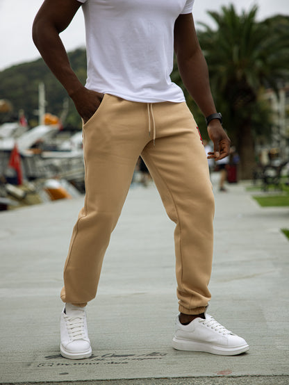 Pantalón de chándal L.A. de algodón y poliéster, diseño cómodo con puños en los tobillos, estilo deportivo y urbano en color beige